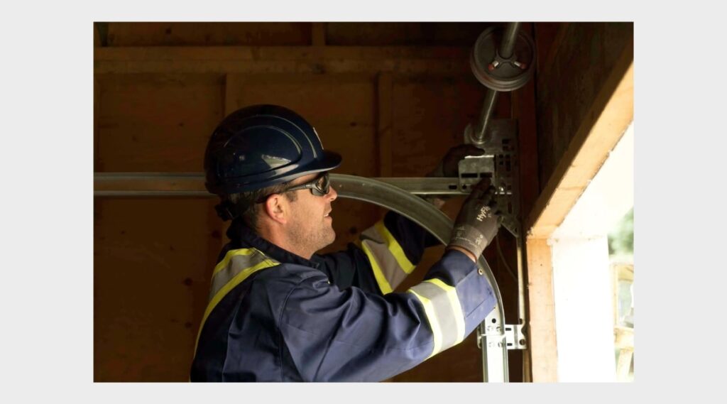 A professional technician repairing a garage door roller with tools in hand, demonstrating proper maintenance and repair. The technician is focused on the roller, showcasing the importance of expert intervention.