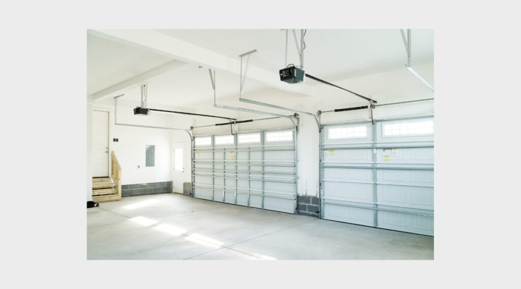 "A calm, quiet garage environment with a high-quality, energy-efficient garage door in operation, symbolizing reduced noise and energy savings for homeowners."
